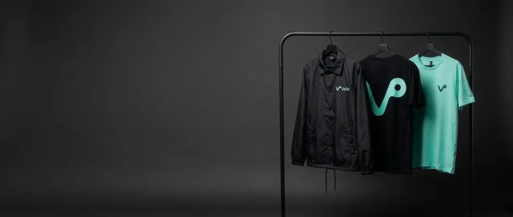 Portant avec la collection de lancement Velto : veste, t-shirt noir et t-shirt menthe